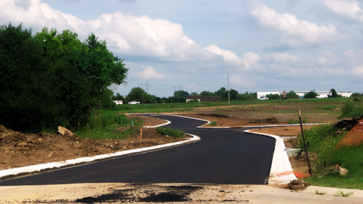 Newly paved road through residential land development site